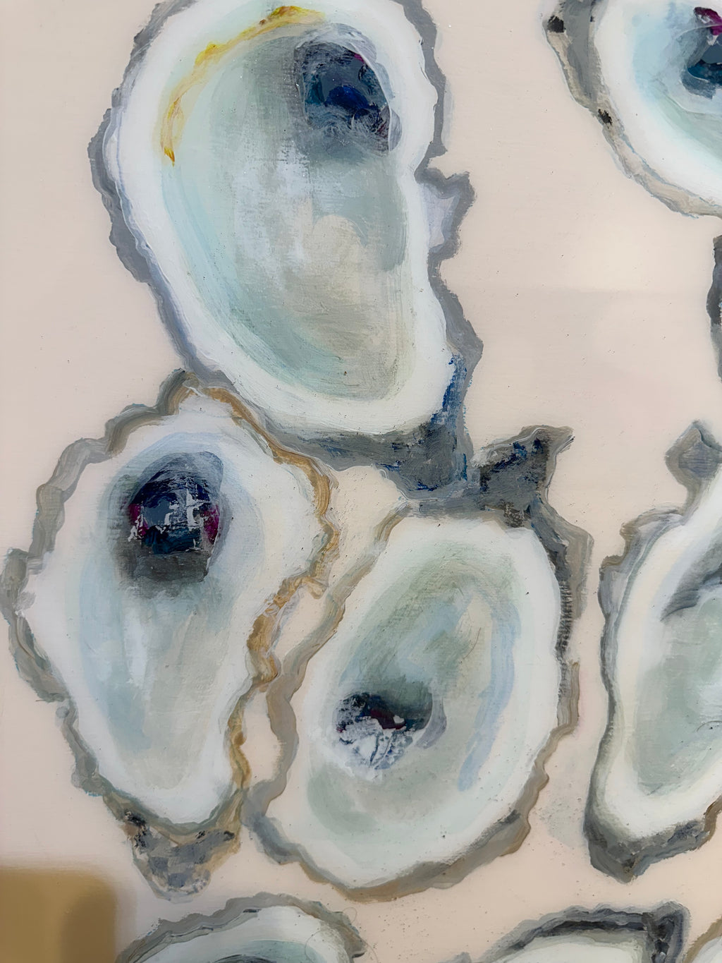 Closeup aerial view of oysters in front of blush background