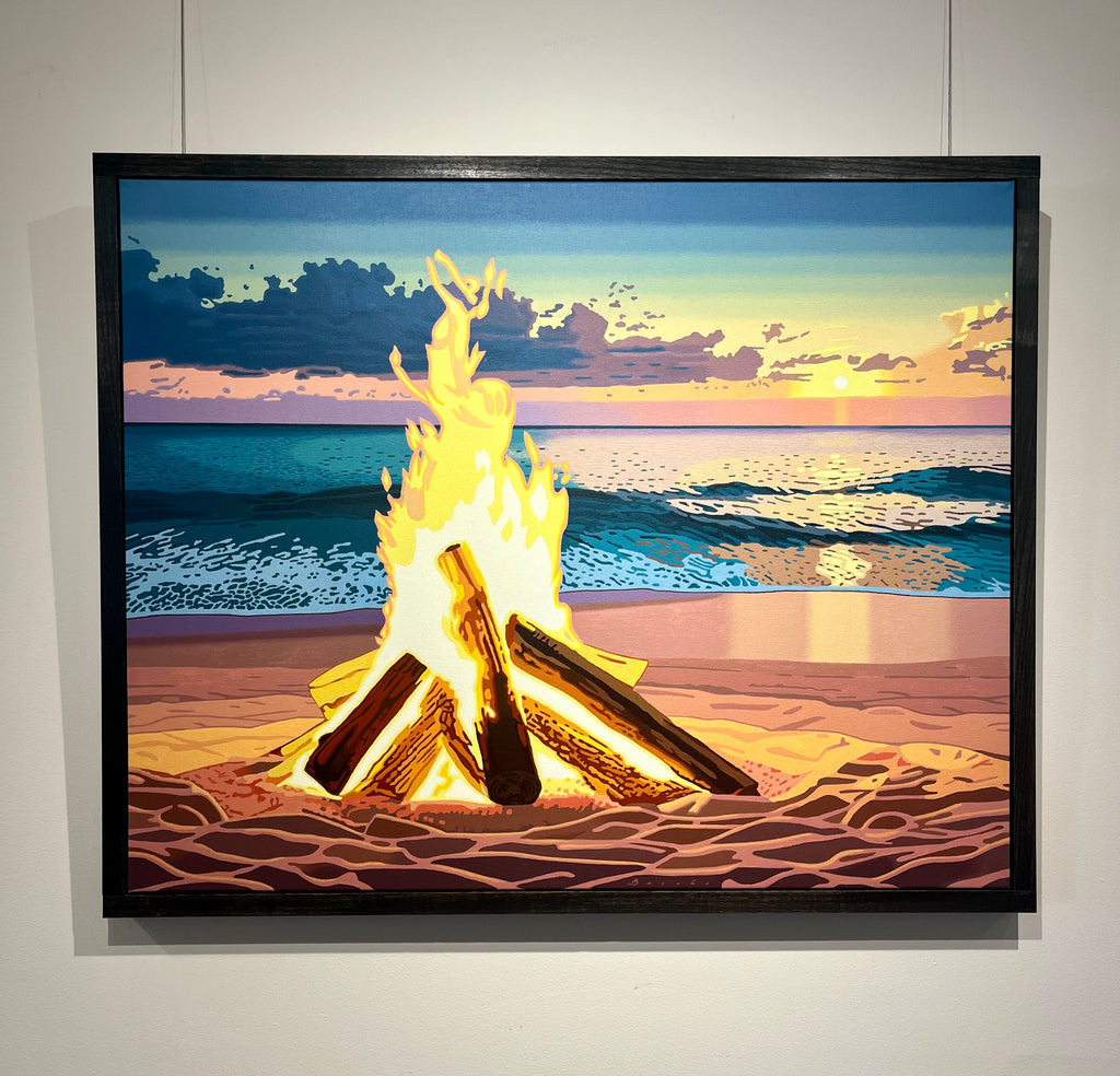 Bright beach fire in front of a setting sun