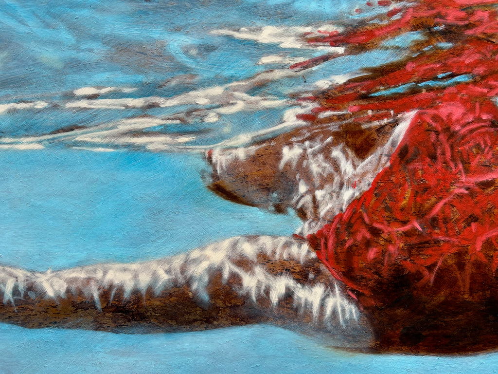 large, bright blue painting of a woman in a red bathing suit, gliding beneath the surface of the water.