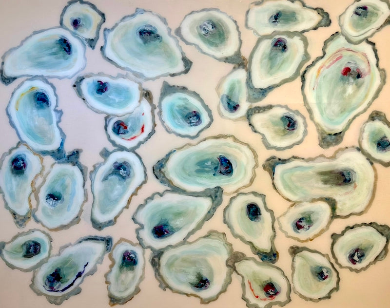 Closeup aerial view of oysters in front of blush background